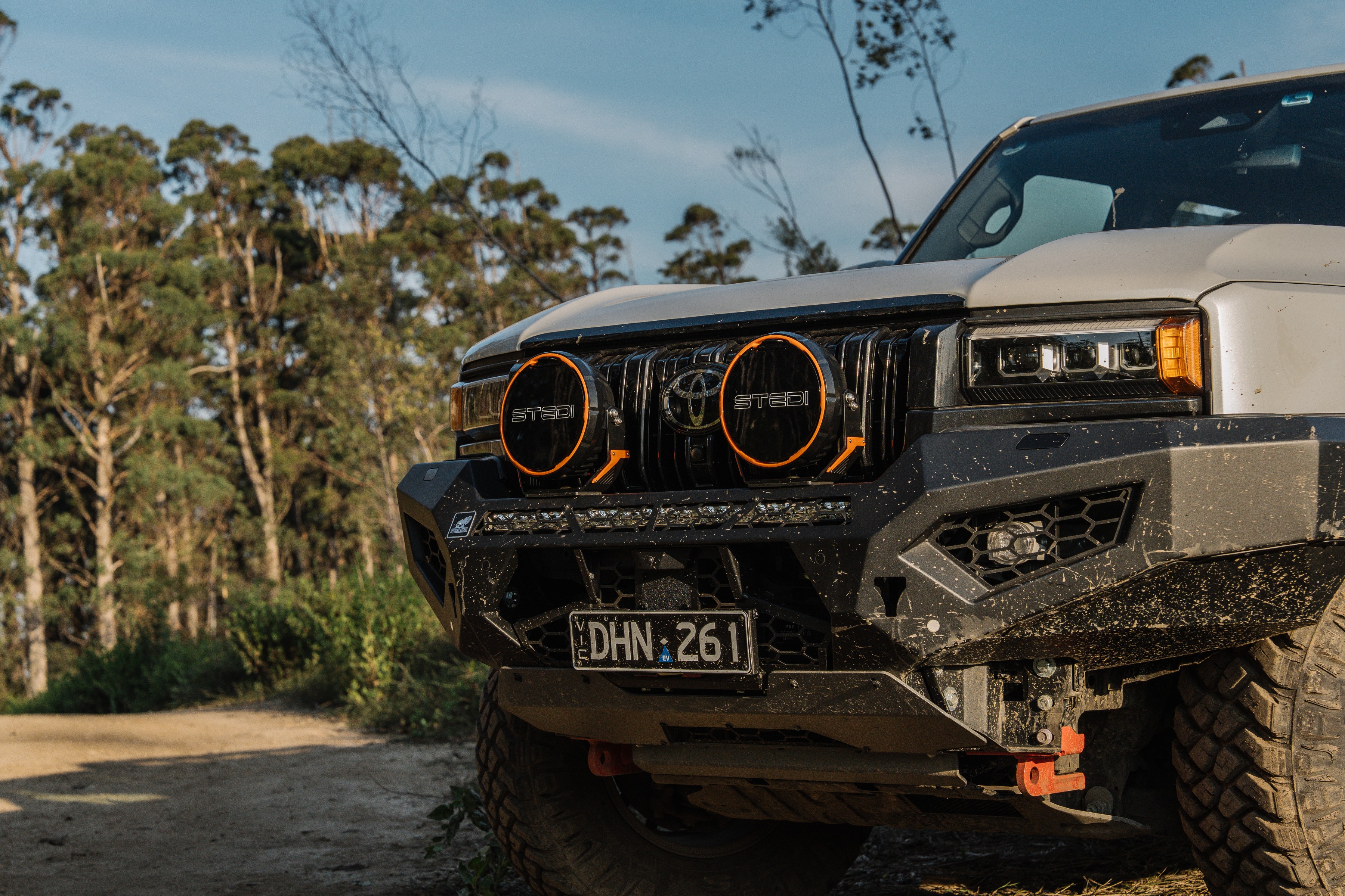 A green Jimny with dual Type-X™ LED Driving Lights shining white light.