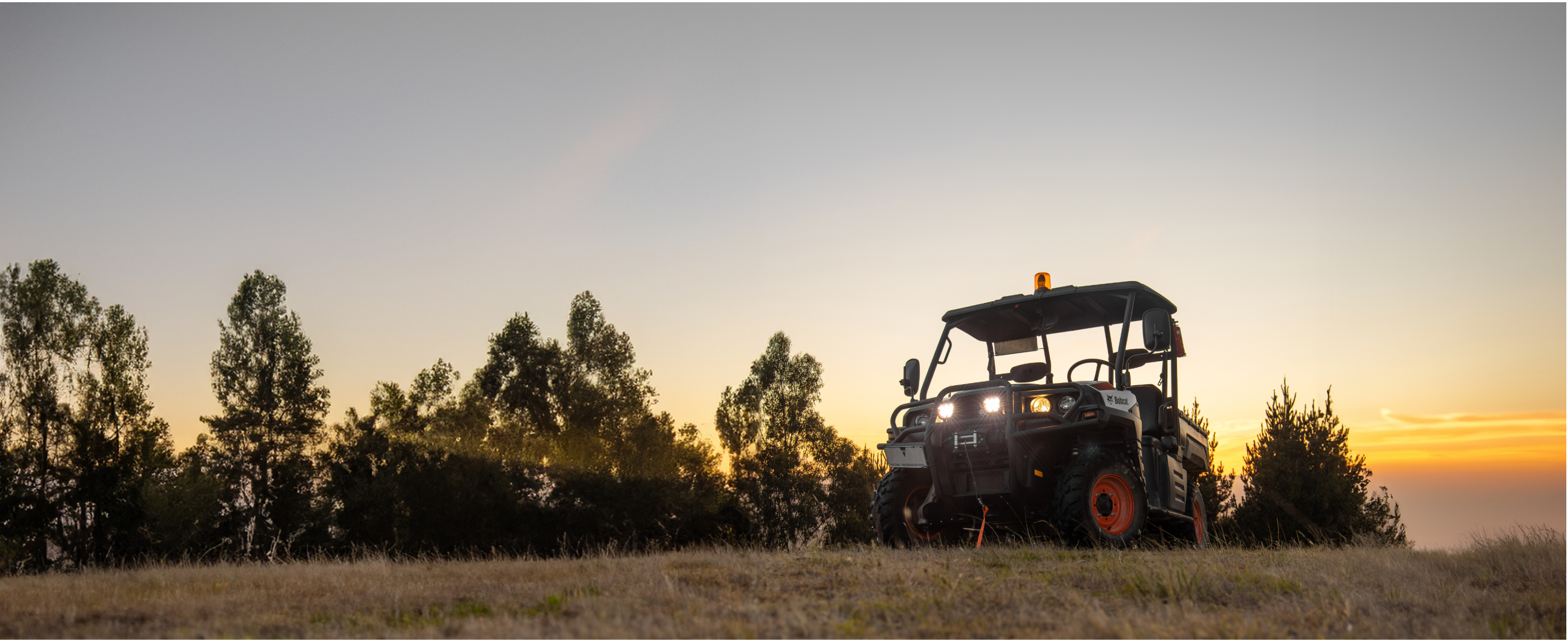 A side by side, with double EVO Mini driving lights, shining at sundown.